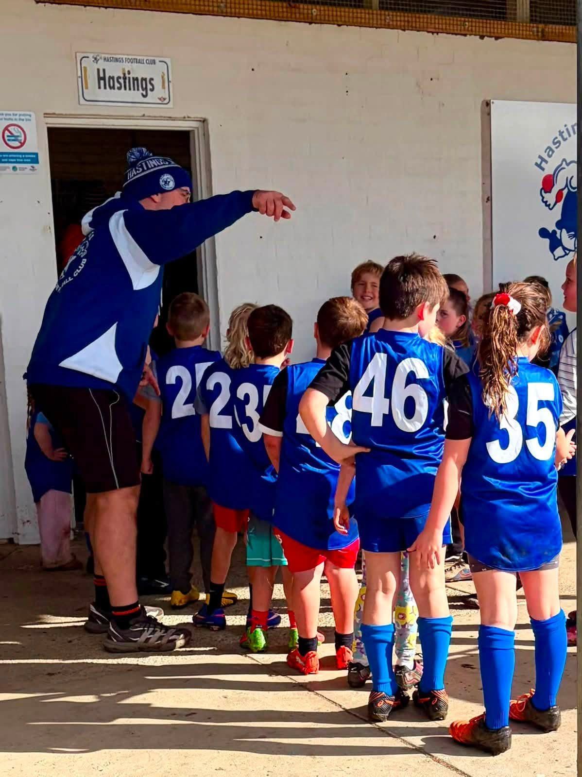 Hastings juniors line up at the change-room door, ready to run out for their game.